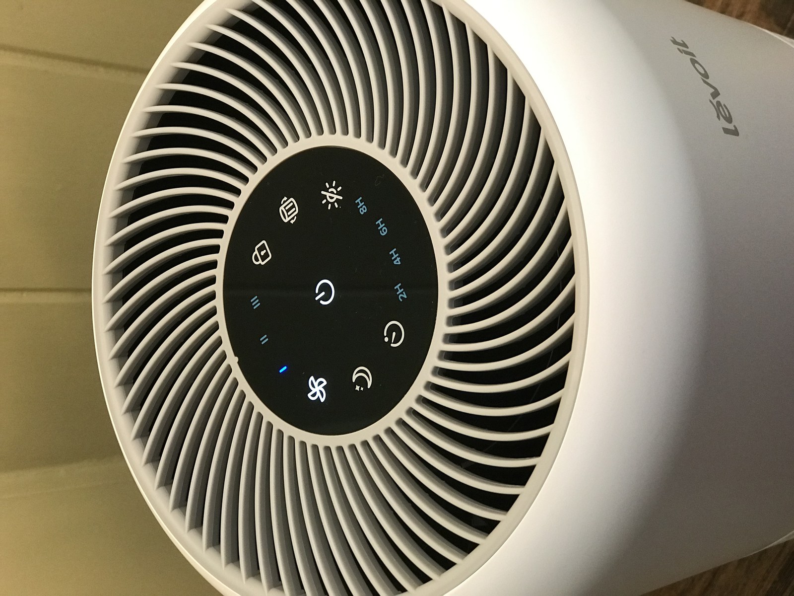 Close view of the Levoit Core 300 control panel and top air outlet.